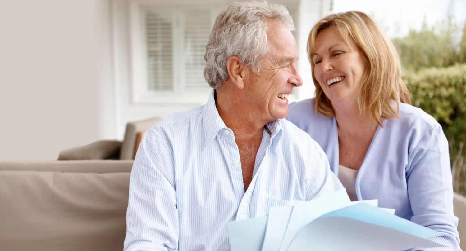 Photo of a couple sitting on a sofa with paperwork